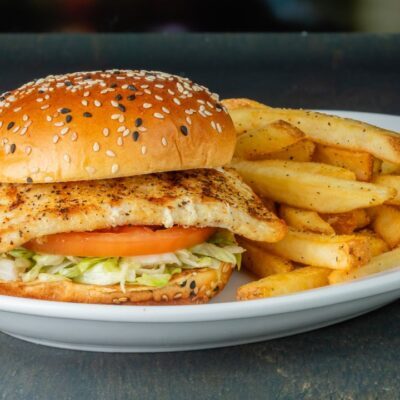 mahi mahi sandwich on a plate with fries from millers ale house